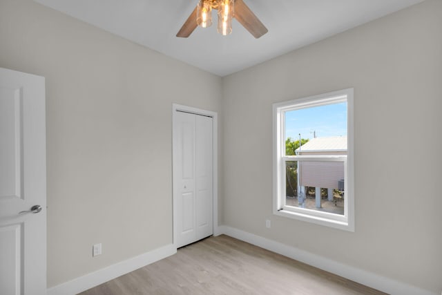 22737 Blackbeard Ln, Cudjoe, FL 33042 - unfurnished bedroom with light wood-type flooring, ceiling fan, baseboards, and a closet