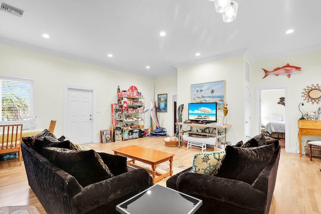 living room with crown molding and light wood-type flooring