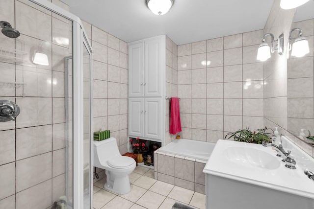 full bathroom featuring toilet, tile walls, vanity, independent shower and bath, and tile patterned flooring