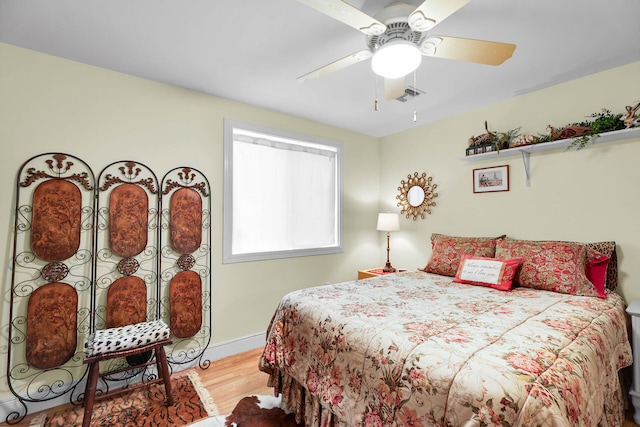 bedroom with wood-type flooring and ceiling fan