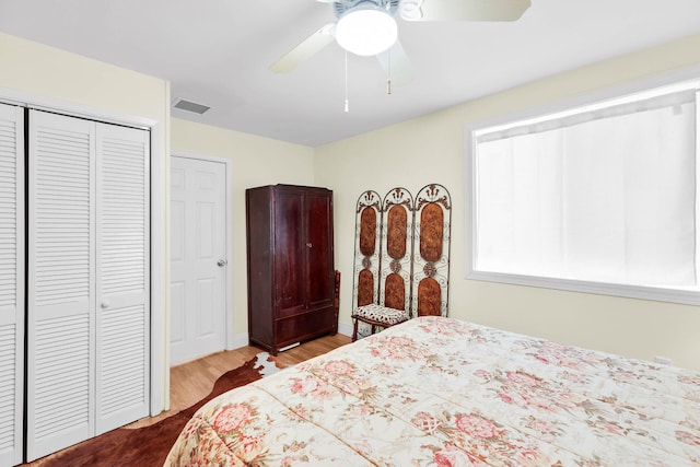 bedroom with ceiling fan, hardwood / wood-style floors, and a closet