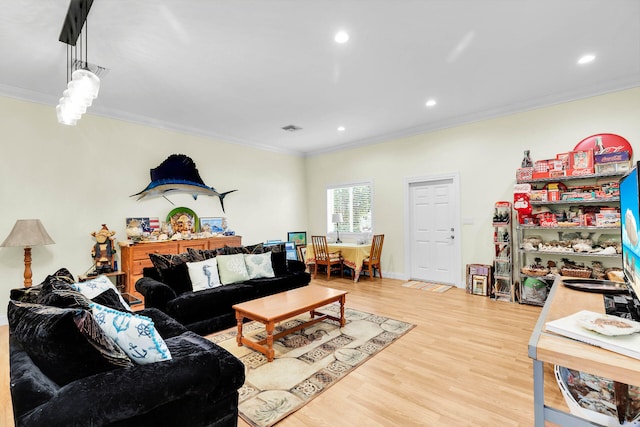 living room with crown molding and light hardwood / wood-style flooring