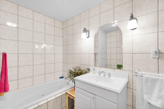 bathroom featuring tile walls, vanity, and a relaxing tiled tub