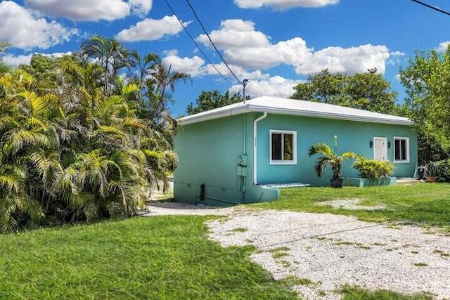 view of home's exterior with a lawn