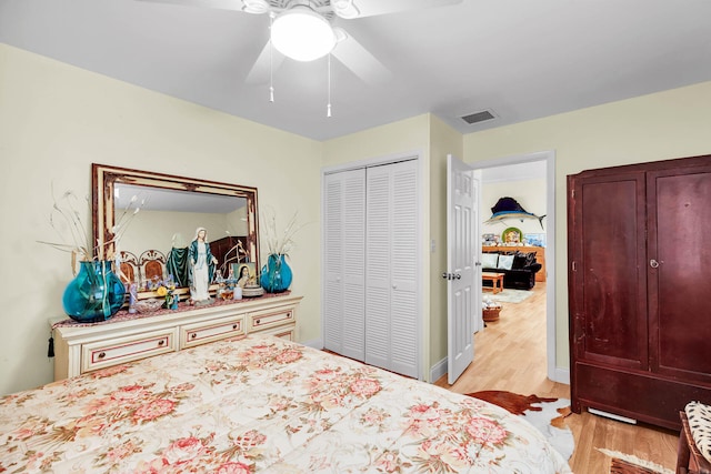 bedroom featuring light hardwood / wood-style flooring, a closet, and ceiling fan