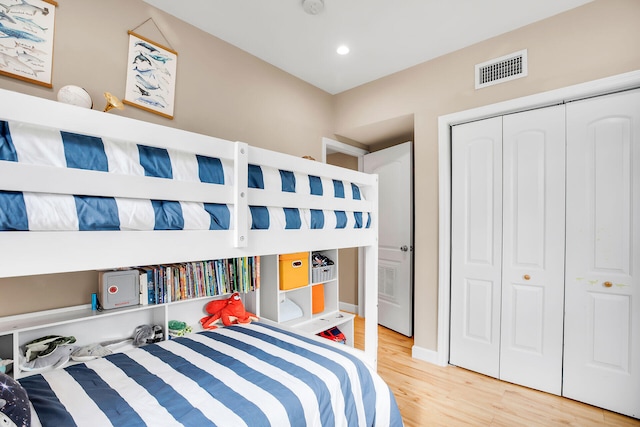 bedroom featuring wood-type flooring and a closet