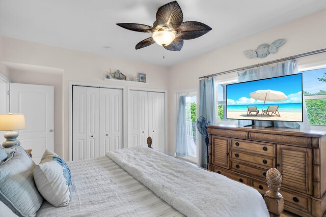 bedroom with access to outside, two closets, and ceiling fan