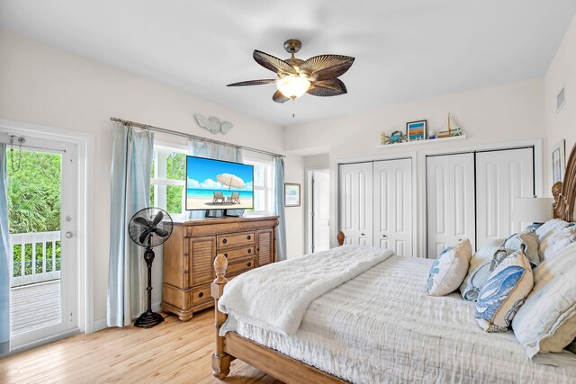 bedroom featuring access to exterior, ceiling fan, multiple closets, and light wood-type flooring