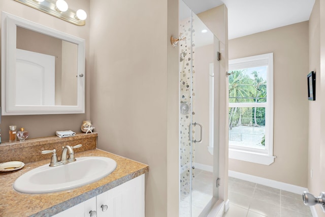 bathroom with vanity, a shower with shower door, and tile patterned flooring