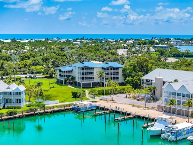 exterior space with a dock, a water view, and a lawn