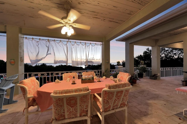 patio terrace at dusk with a ceiling fan