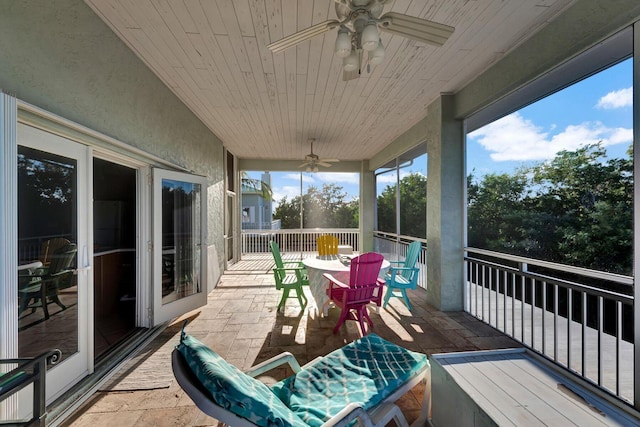 sunroom / solarium with wood ceiling and ceiling fan