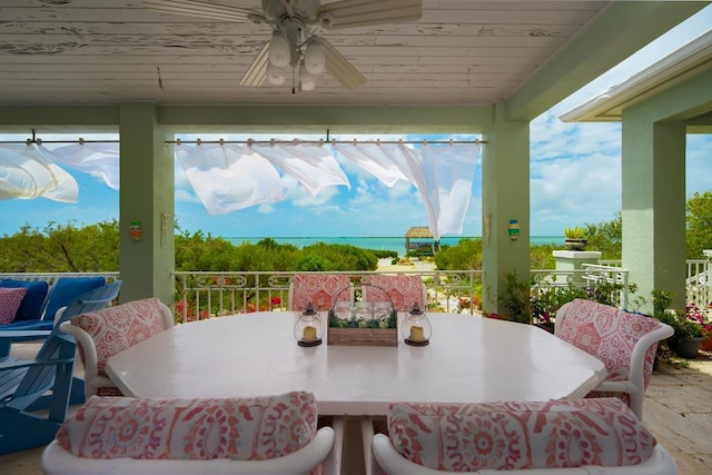 view of patio featuring a balcony, outdoor dining area, and a ceiling fan