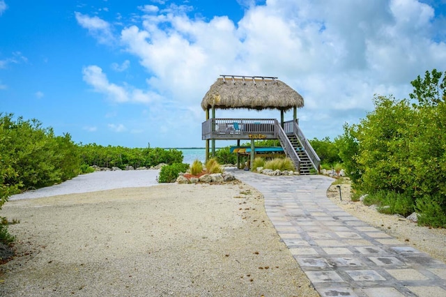 view of property's community featuring a water view, a gazebo, and stairs