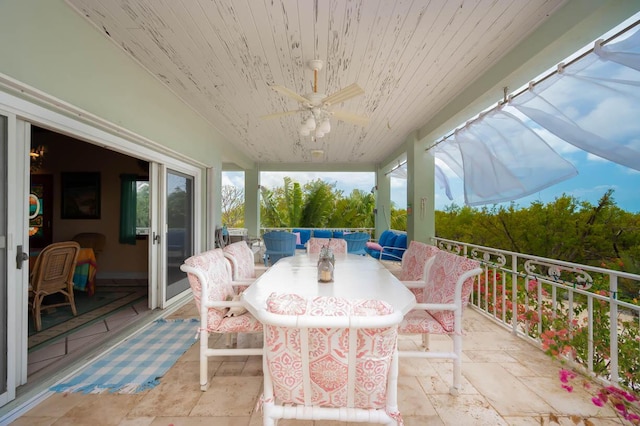 sunroom with ceiling fan, a wealth of natural light, and wood ceiling