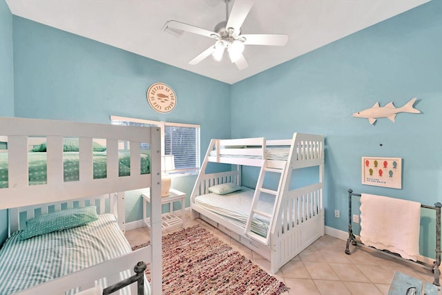 bedroom with tile patterned flooring, baseboards, and a ceiling fan