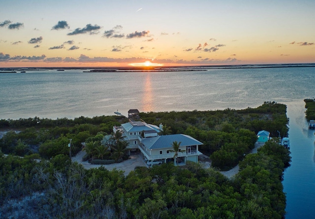 aerial view at dusk with a water view