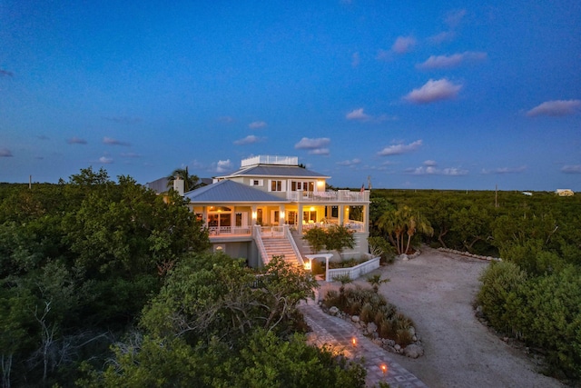 view of front of home featuring driveway and stairway