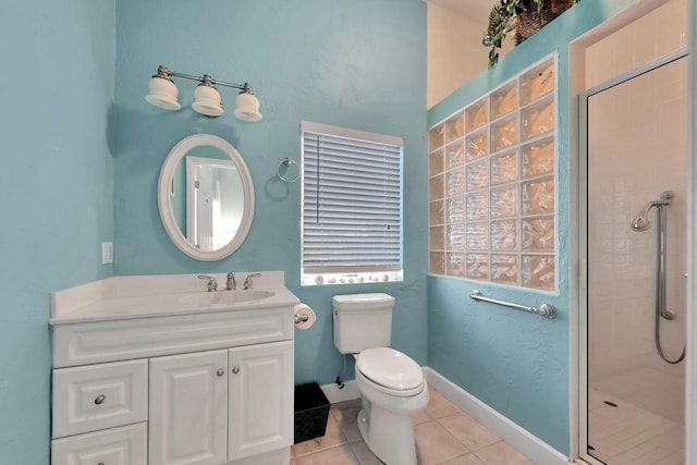 bathroom with toilet, a stall shower, vanity, tile patterned flooring, and baseboards