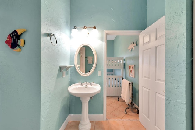 bathroom featuring tile patterned flooring and baseboards