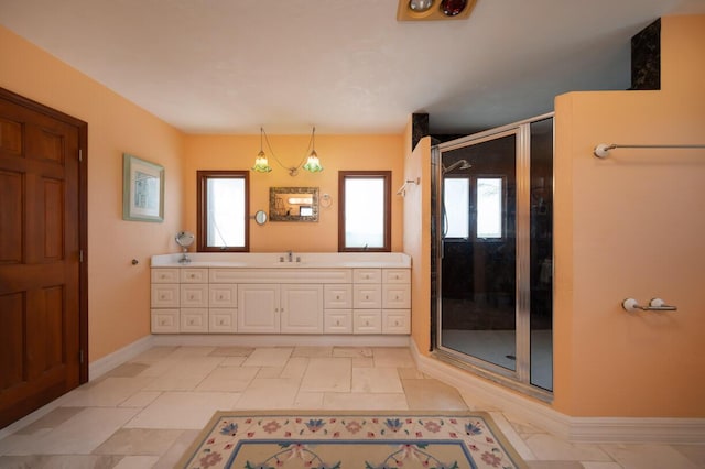 full bathroom with a shower stall, vanity, and baseboards