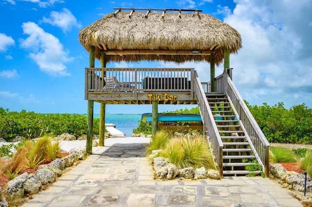 exterior space with a water view, stairway, and a gazebo