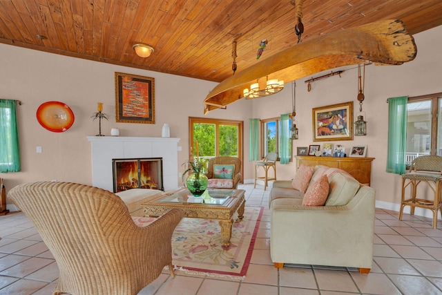 living room featuring light tile patterned flooring, wood ceiling, baseboards, a tiled fireplace, and an inviting chandelier