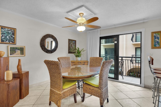 dining space featuring light tile patterned floors, crown molding, a textured ceiling, and ceiling fan