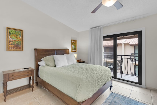 tiled bedroom with ceiling fan, vaulted ceiling, a textured ceiling, and access to outside