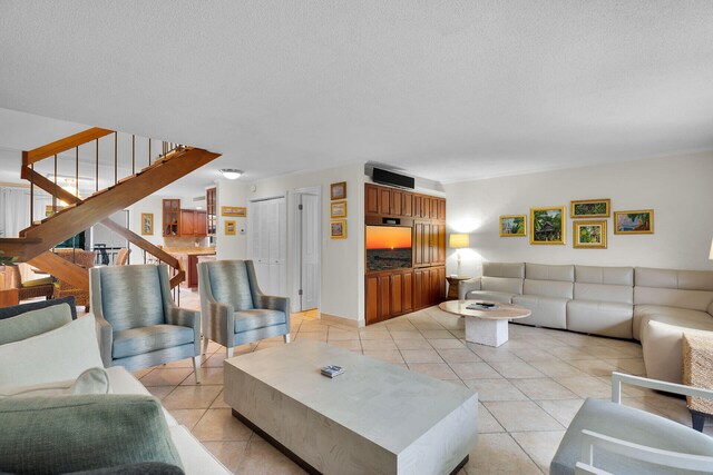 living room with light tile patterned floors and a textured ceiling