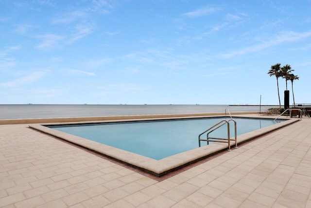 view of pool featuring a water view