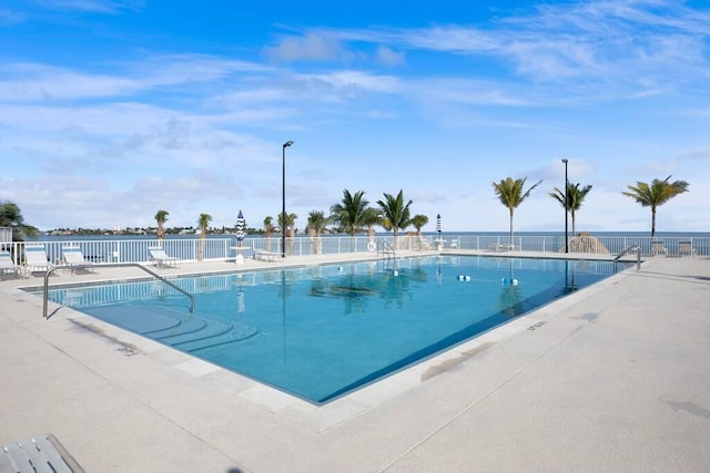 pool featuring a patio area and fence