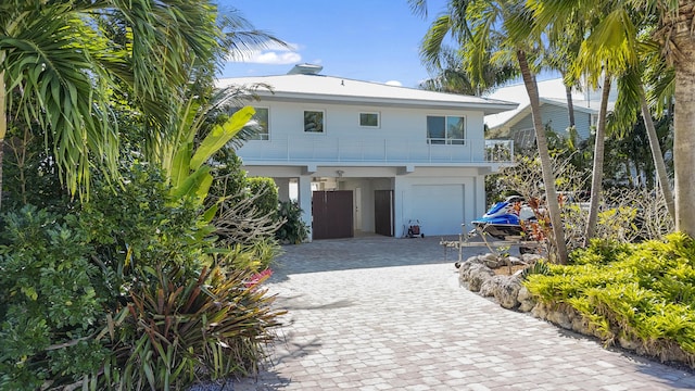 view of front of house with a garage and a balcony