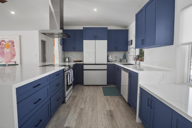 kitchen featuring sink, ventilation hood, appliances with stainless steel finishes, kitchen peninsula, and light hardwood / wood-style floors