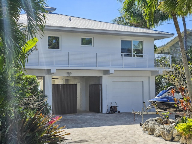 view of front of home with a garage and a balcony