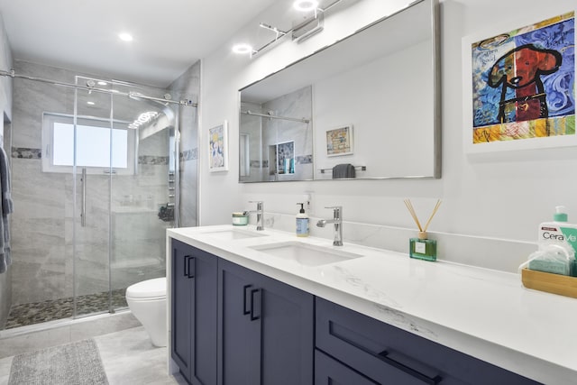 bathroom featuring vanity, a shower with shower door, and toilet