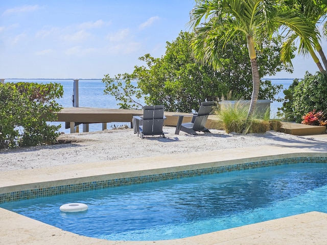 view of pool with a water view