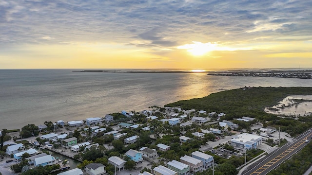 aerial view at dusk with a water view