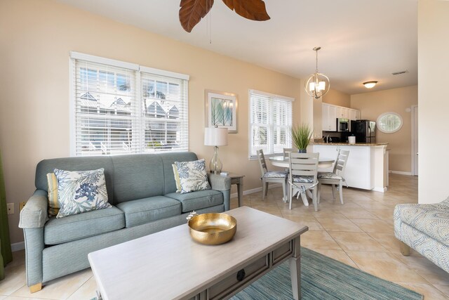 living room featuring ceiling fan and light tile patterned floors