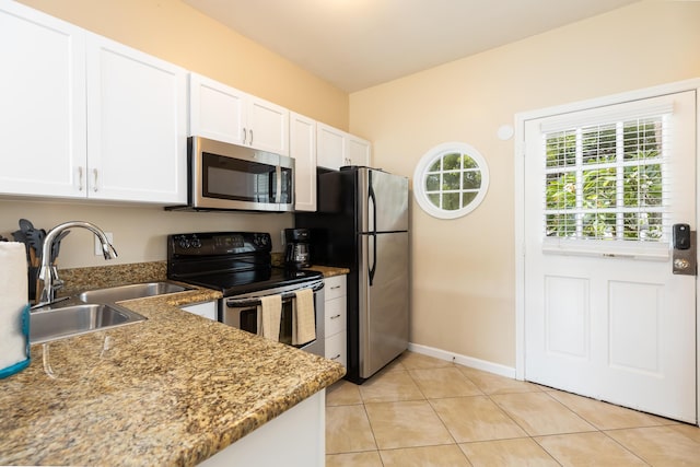 kitchen featuring sink, light tile patterned flooring, white cabinets, and appliances with stainless steel finishes