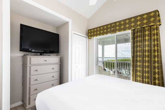 bedroom featuring vaulted ceiling, access to outside, and a closet