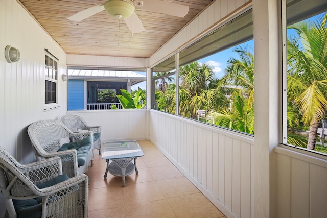 sunroom / solarium featuring wood ceiling and ceiling fan