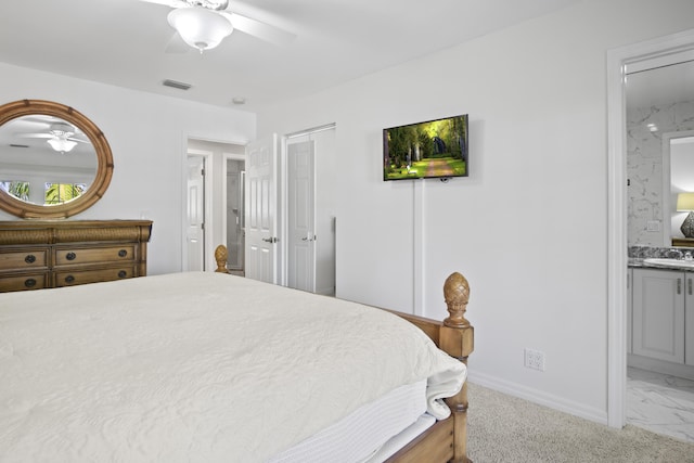 bedroom featuring ensuite bathroom, sink, ceiling fan, and a closet