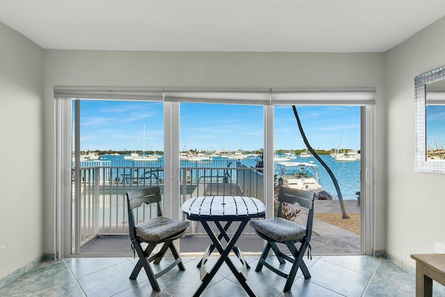 sunroom featuring a healthy amount of sunlight and a water view