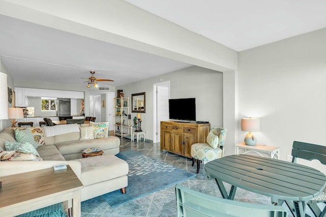 tiled living room with ceiling fan