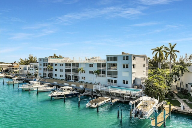 view of pool with a water view and a dock