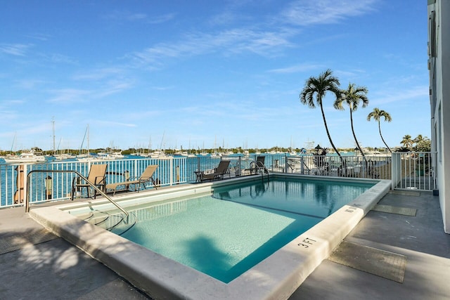 view of pool with a water view