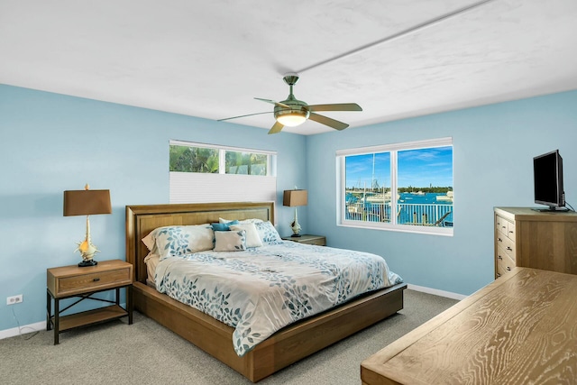 bedroom with light carpet and ceiling fan