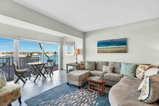 tiled living room featuring a water view