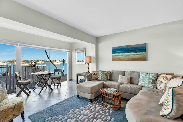 living room with a water view and tile patterned floors